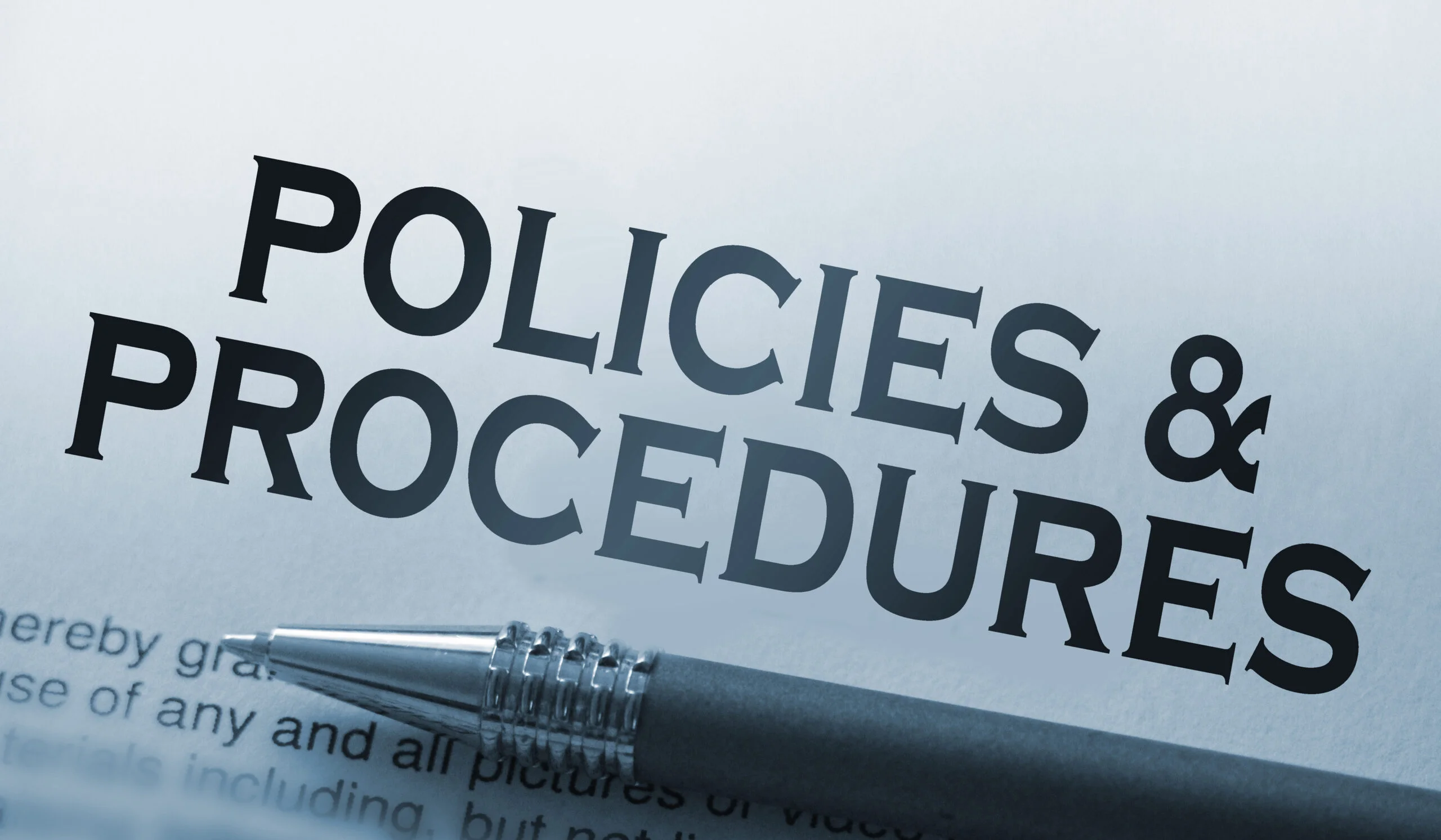 Policies and procedures memo typed on a notebook with pen. Business rules concept.