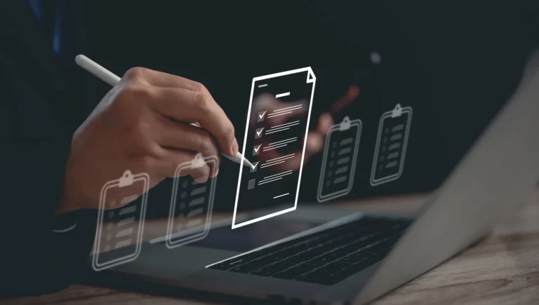 Businessman using laptop for checklist, and filling out a survey form online.